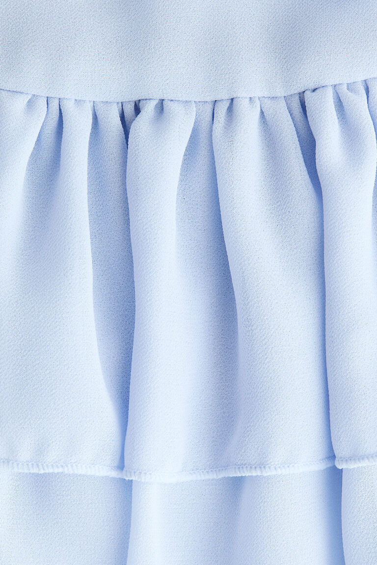 Blus depan ikat dengan detail ruffle